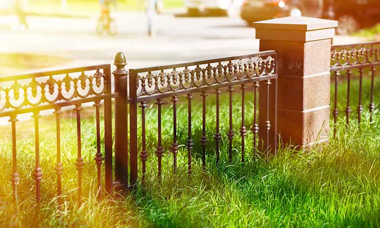 Wrought iron fence with block columns
